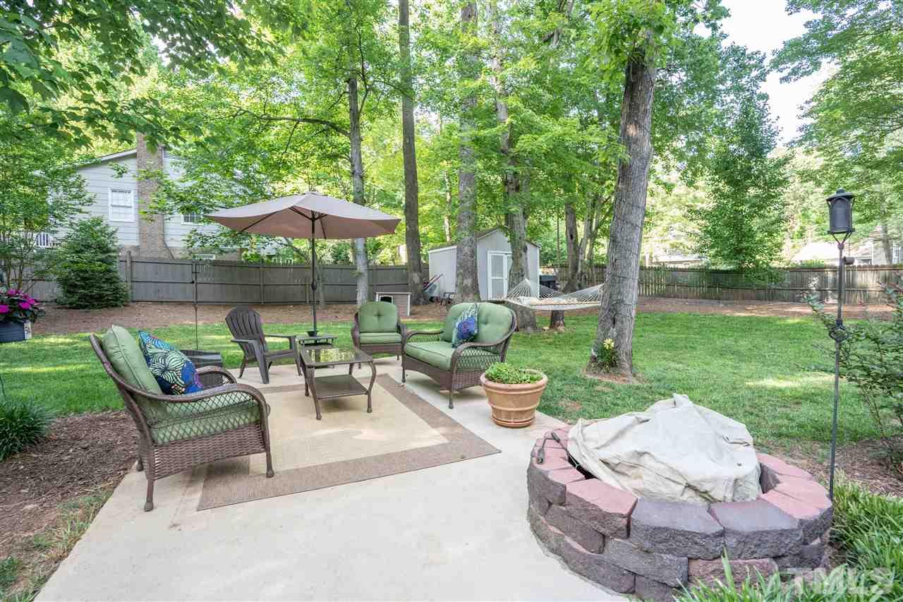 7500 Mine Valley Road Raleigh, NC 27615 - Photo 23 of 25 a view of a patio with couches table and chairs under an umbrella