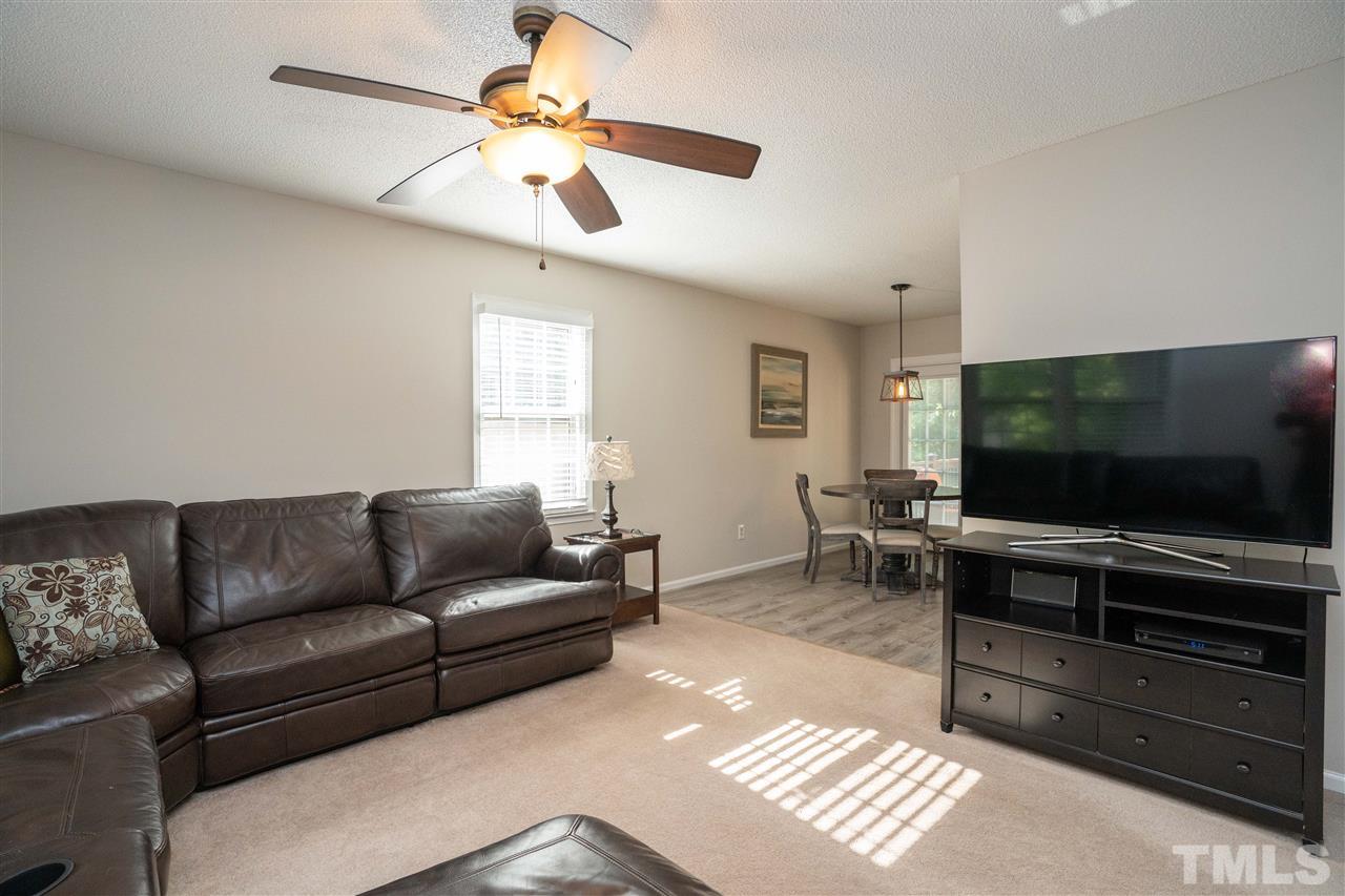 7500 Mine Valley Road Raleigh, NC 27615 - Photo 4 of 25 a living room with furniture and a flat screen tv