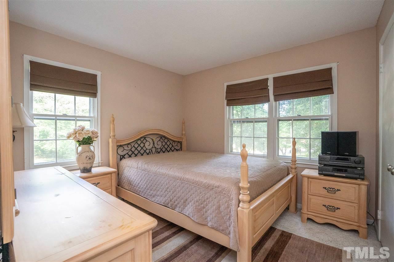 7500 Mine Valley Road Raleigh, NC 27615 - Photo 10 of 25 a bedroom with a large bed and a flat tv screen on dresser