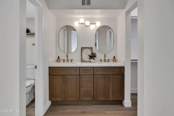 a bathroom with a double vanity sink and a mirror