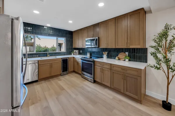a kitchen with sink a microwave and cabinets