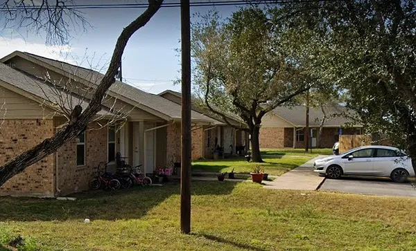 a view of a yard with car parked in front of it