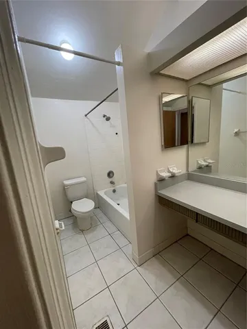 a bathroom with a sink a toilet and mirror