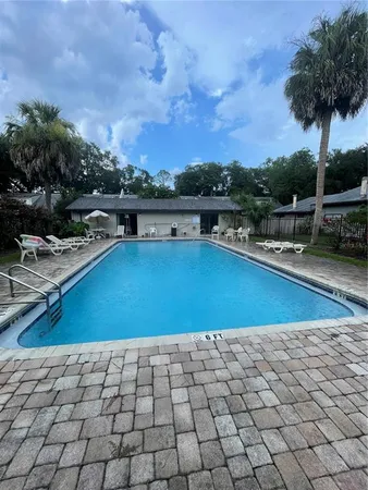 a view of a swimming pool and lounge chair