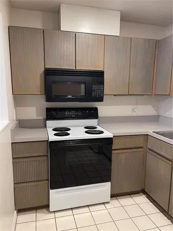 a kitchen with granite countertop a stove and a sink