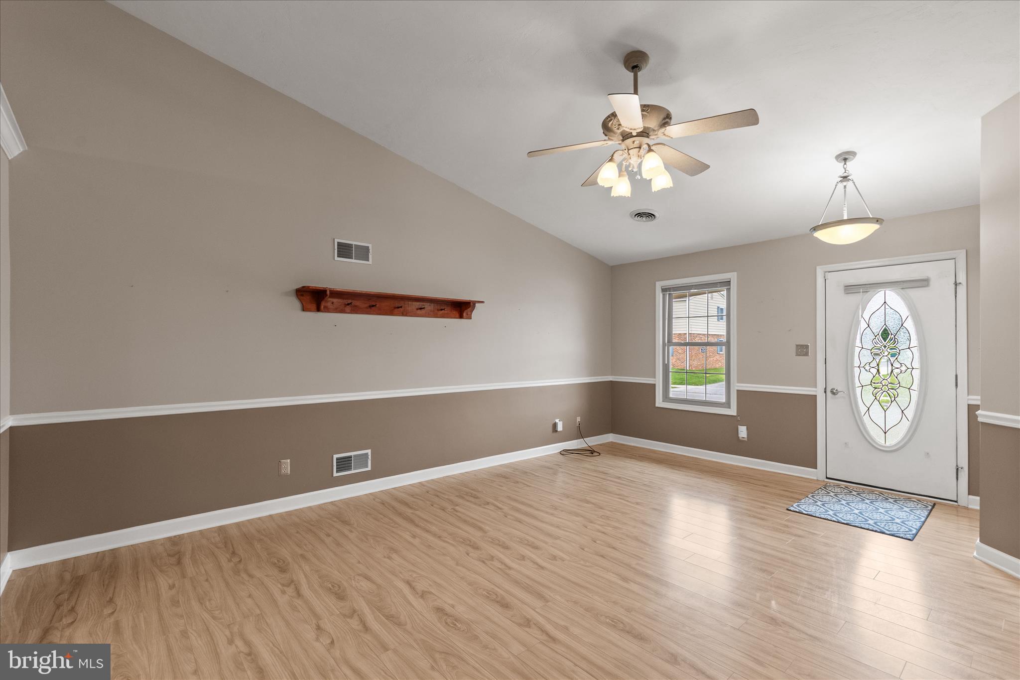 714 Randolph Street Hanover, PA 17331 - Photo 7 of 33 a view of an empty room with window and wooden floor
