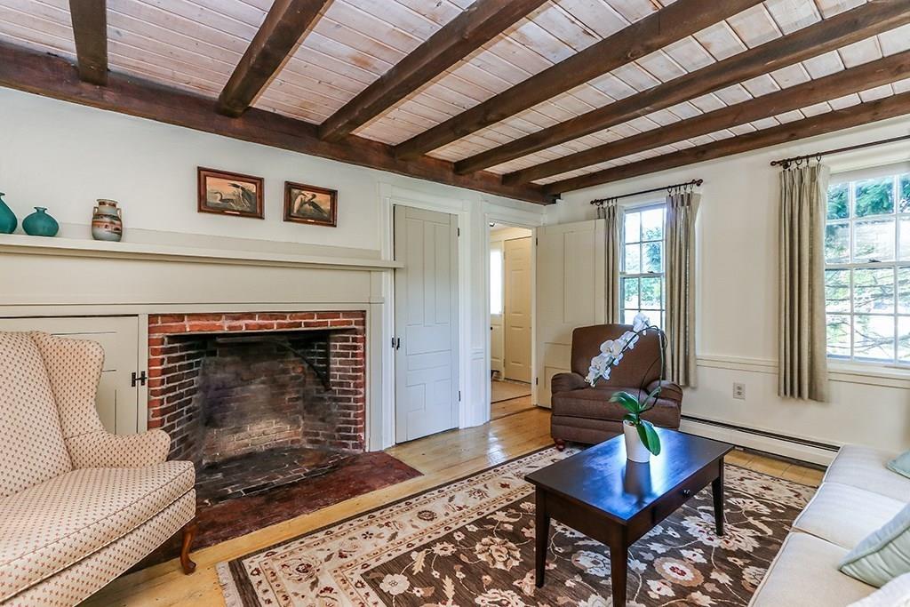 1401 Bay Road Sharon, MA 02067 - Photo 12 of 37 a living room with furniture and a fireplace