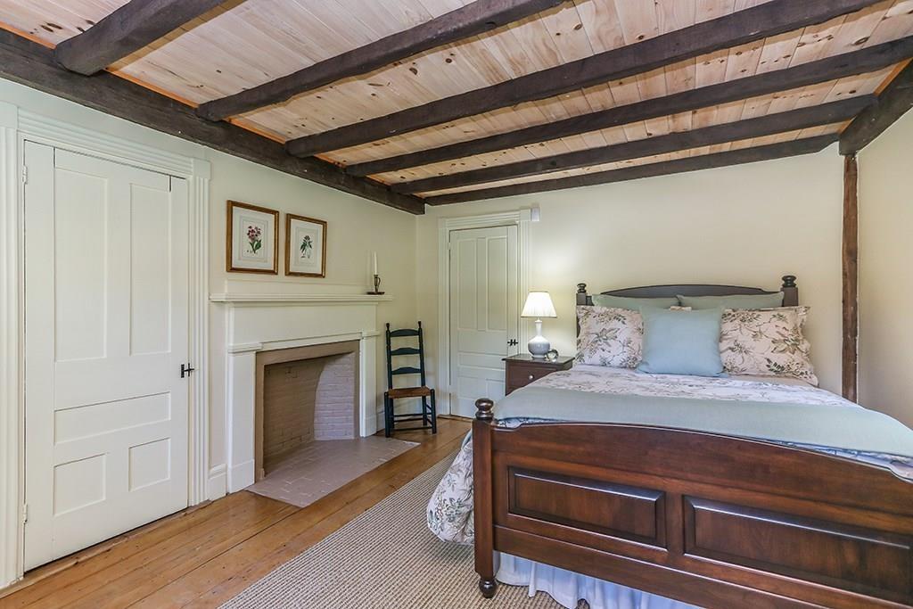 1401 Bay Road Sharon, MA 02067 - Photo 24 of 37 a spacious bedroom with a bed and a fireplace