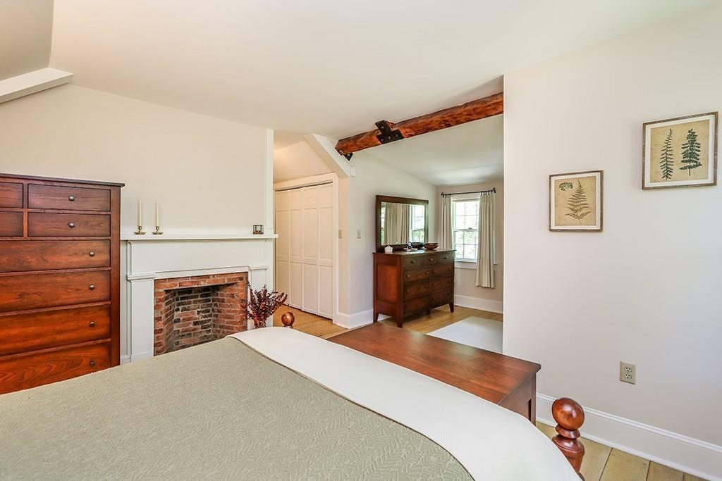 1401 Bay Road Sharon, MA 02067 - Photo 26 of 37 a bedroom with a bed and a fireplace