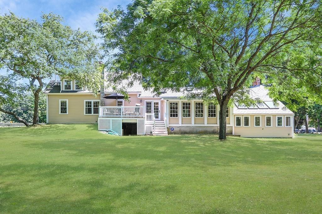 1401 Bay Road Sharon, MA 02067 - Photo 5 of 37 a front view of a house with a garden