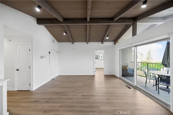 an empty room with windows and entrance