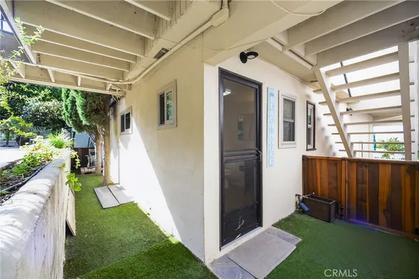 a view of balcony with wooden floor and fence