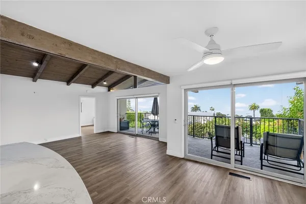 a view of a room with wooden floor and outdoor space