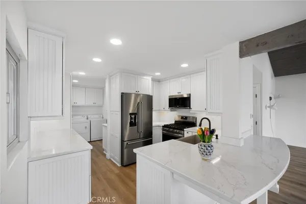 a view of an entryway with wooden floor