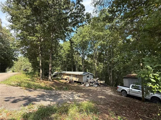 a view of a sitting area with trees in the background
