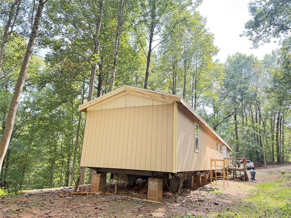4683 Giddon Martin Road Gainesville, GA 30506 - Photo 4 of 7 a view of a small house with a yard and roof