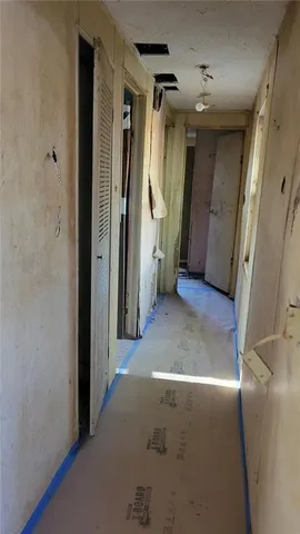 a view of a hallway with wooden shelves