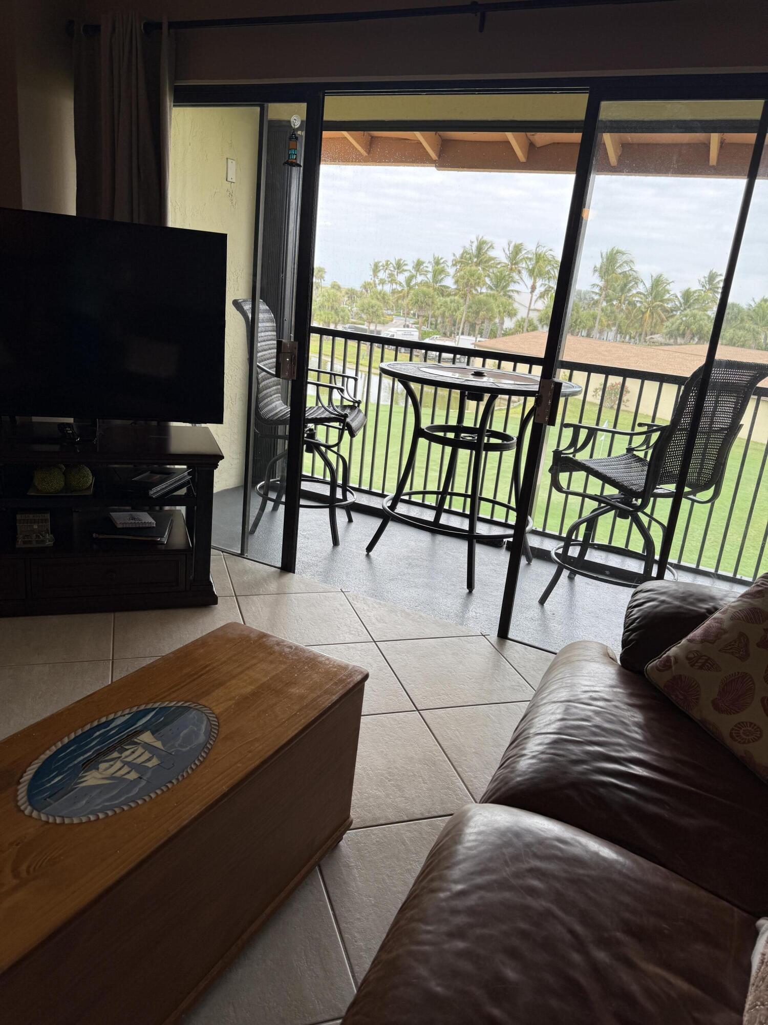 2400 South Ocean Drive, Unit 1034 Fort Pierce, FL 34949 - Photo 14 of 51 a living room with large window and a flat screen tv