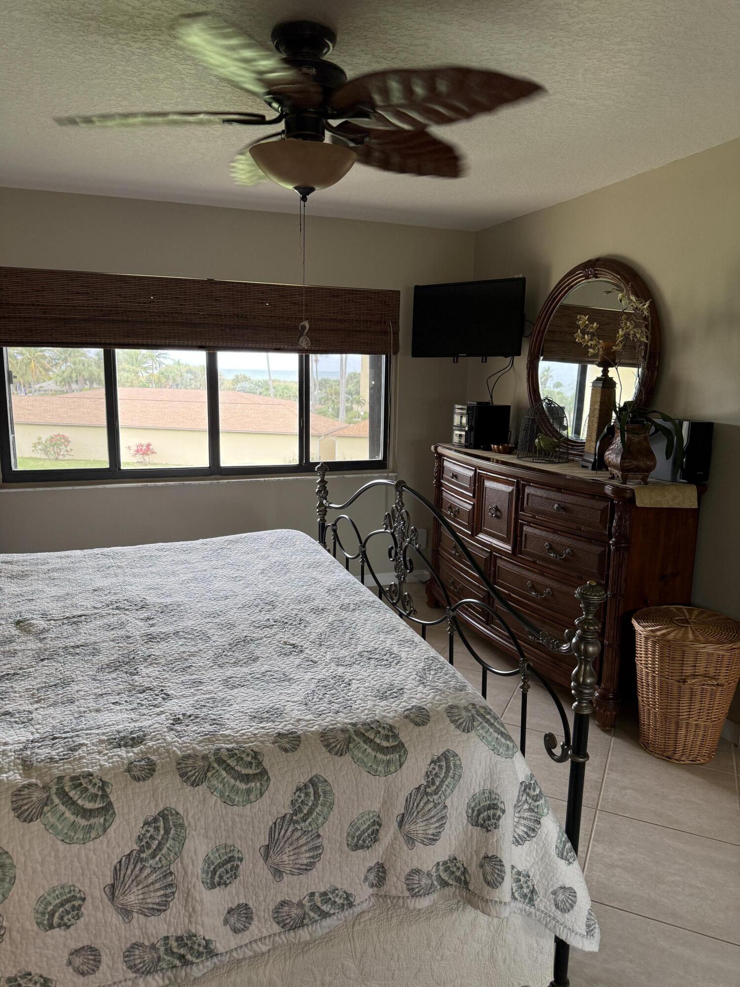 2400 South Ocean Drive, Unit 1034 Fort Pierce, FL 34949 - Photo 18 of 51 a bedroom with a bed a dresser and chair