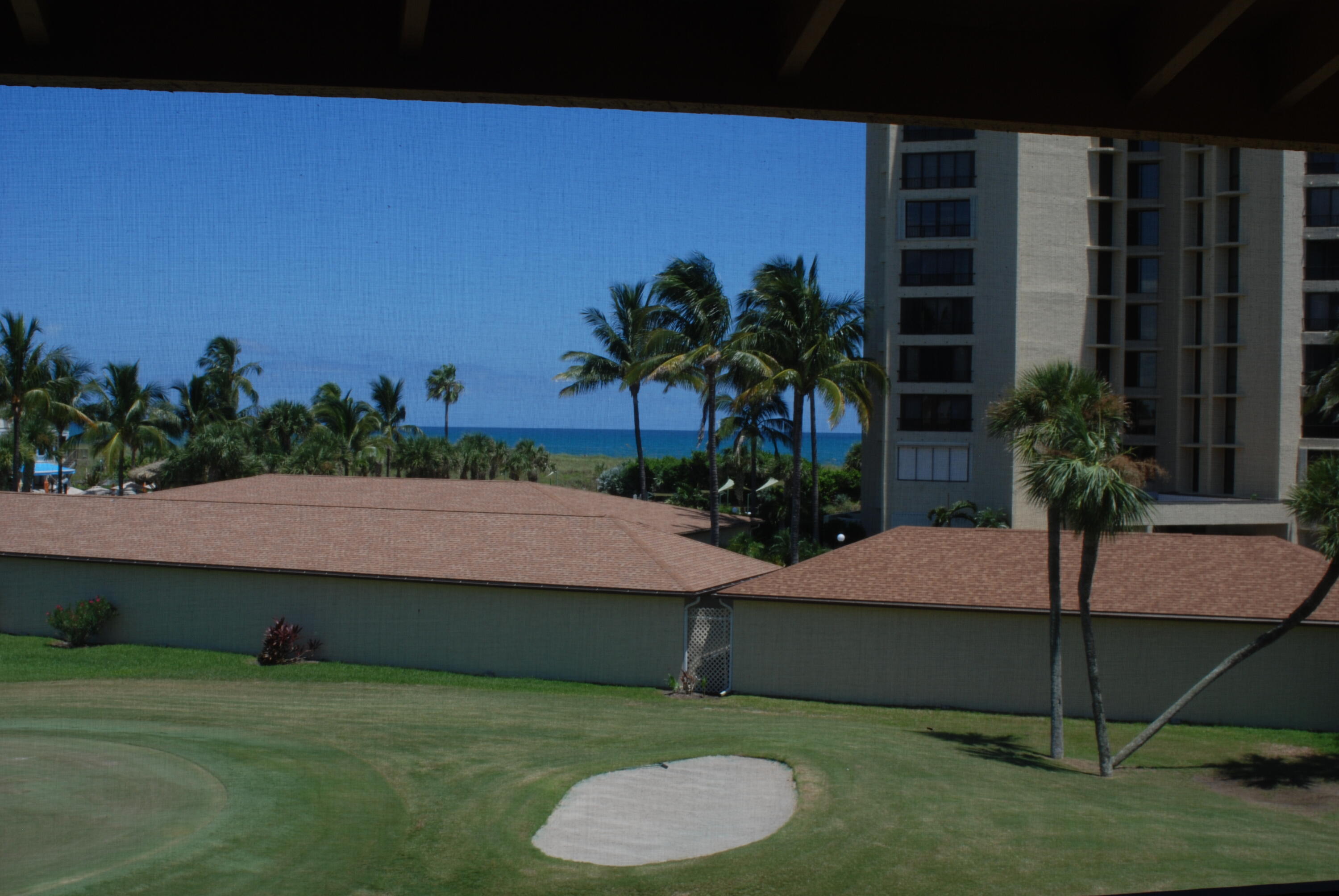 2400 South Ocean Drive, Unit 1034 Fort Pierce, FL 34949 - Photo 26 of 51 a palm tree sitting in front of a house with a yard
