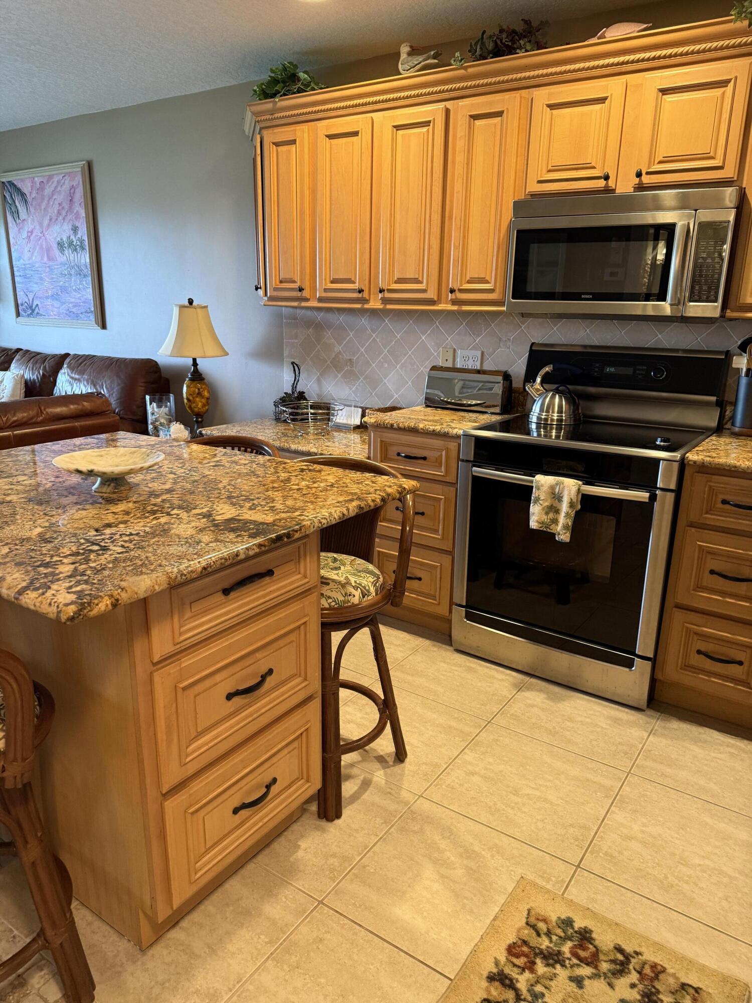 2400 South Ocean Drive, Unit 1034 Fort Pierce, FL 34949 - Photo 5 of 51 a kitchen with a stove and a microwave