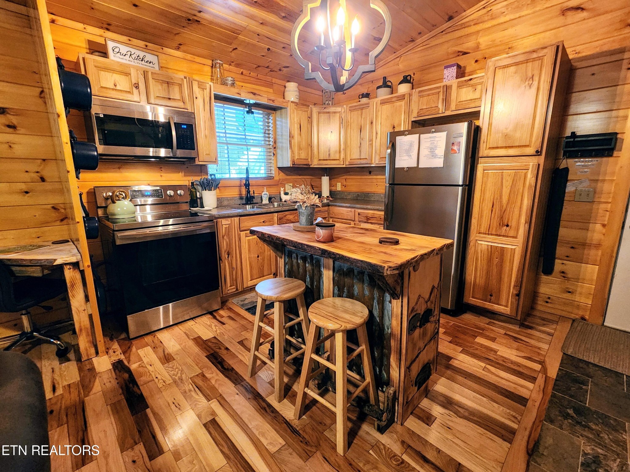 285 Sub Road Cosby, TN 37722 - Photo 4 of 26 a kitchen with stainless steel appliances granite countertop a stove top oven a sink and a dining table with granite countertops