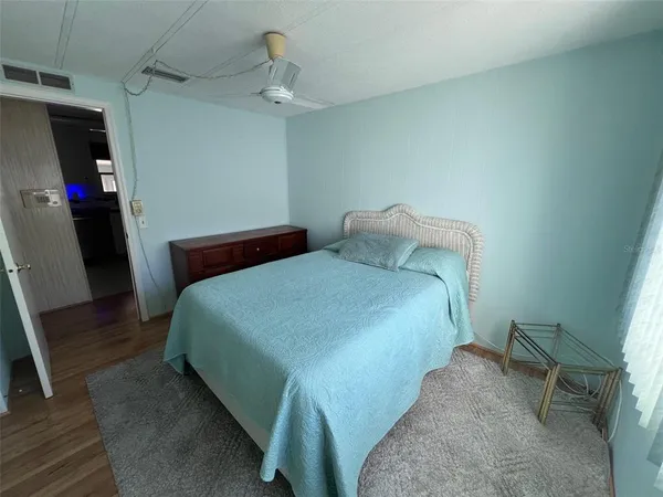 a bedroom with a bed and a mirror