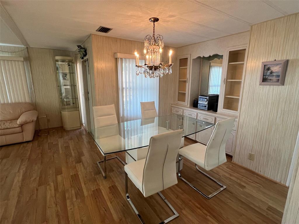 701 Sugar Palm Street Largo, FL 33770 - Photo 14 of 30 a living room with furniture and a chandelier