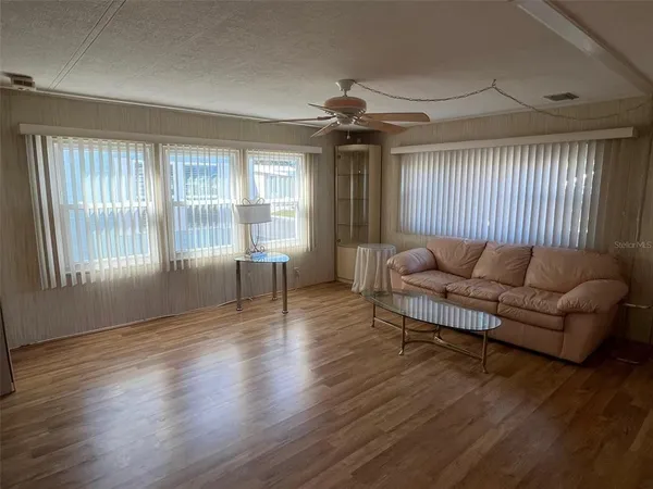 a living room with furniture and a large window