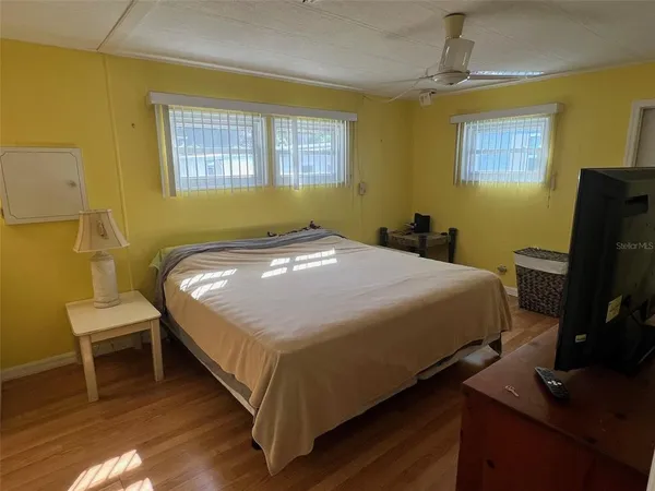 a bedroom with a bed table and chair