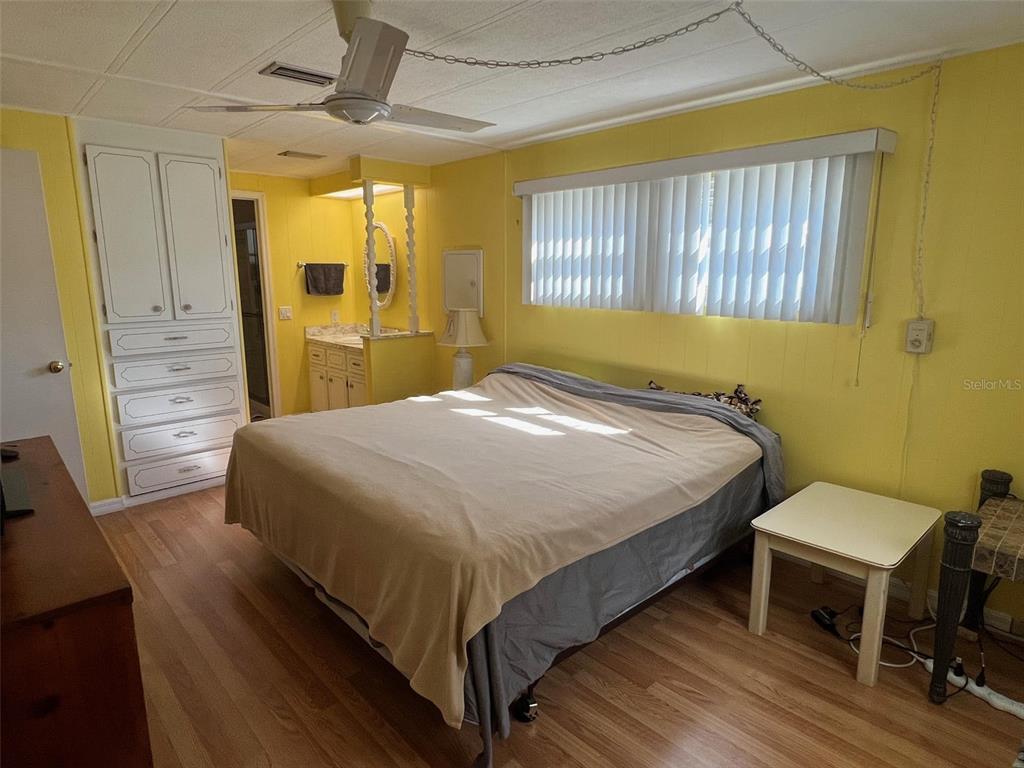 701 Sugar Palm Street Largo, FL 33770 - Photo 25 of 30 a bedroom with a bed and a table in it