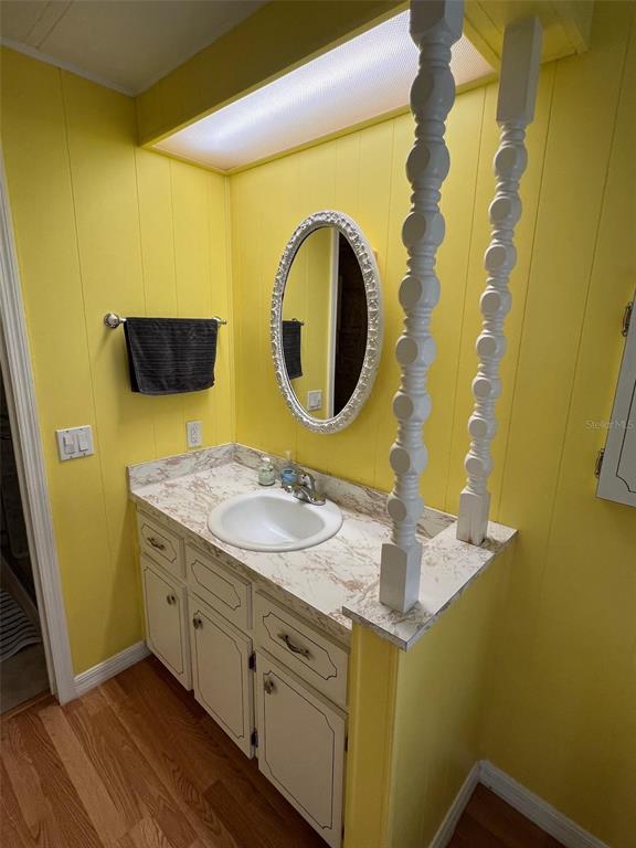 701 Sugar Palm Street Largo, FL 33770 - Photo 27 of 30 a bathroom with a sink and a mirror