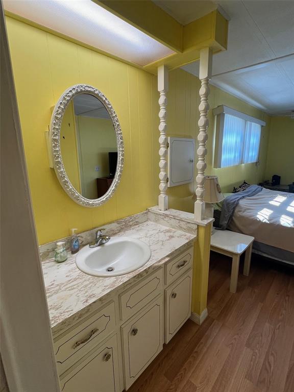 701 Sugar Palm Street Largo, FL 33770 - Photo 28 of 30 a en suite bathroom with a granite countertop double vanity and a mirror
