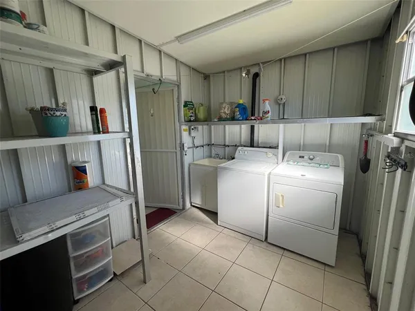 a utility room with cabinets washer and dryer