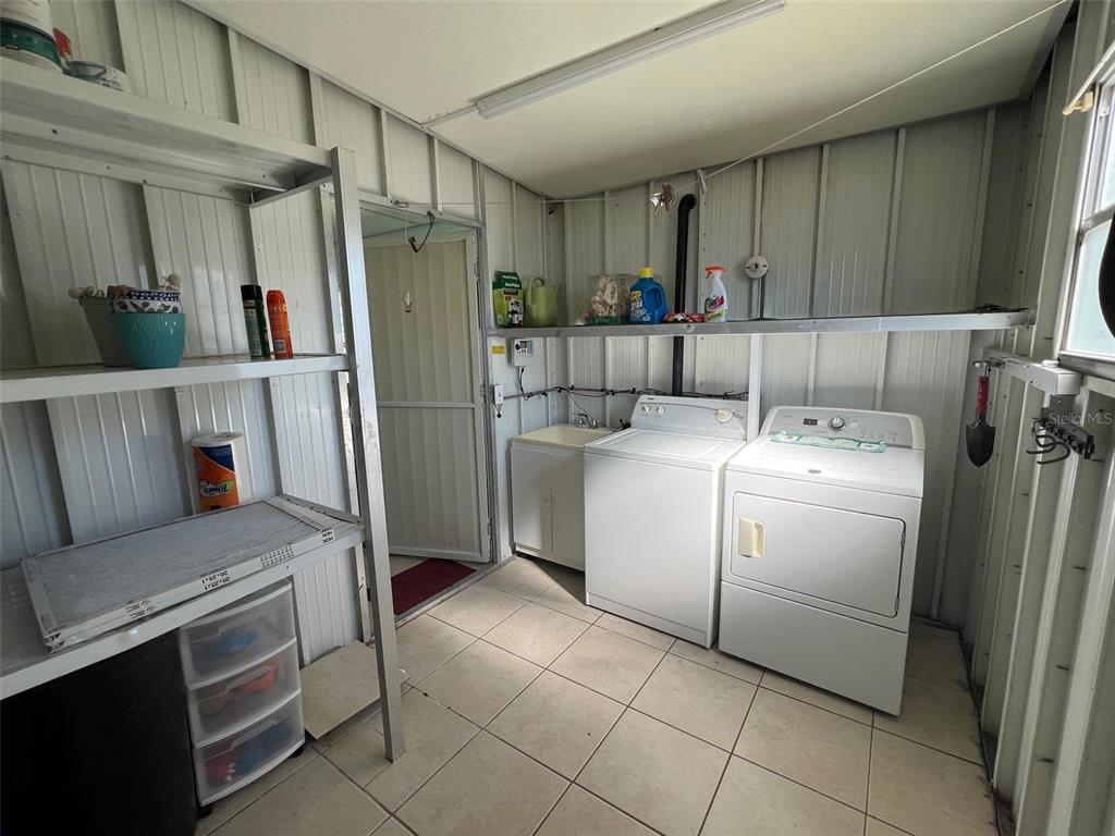 701 Sugar Palm Street Largo, FL 33770 - Photo 7 of 30 a utility room with cabinets washer and dryer