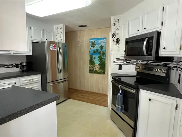 a kitchen with stainless steel appliances a refrigerator stove and microwave