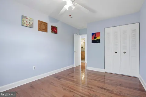 an empty room with wooden floor and window