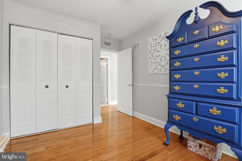 a view of a room with wooden floor closet and windows