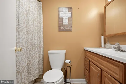 a white toilet sitting next to a bathroom sink