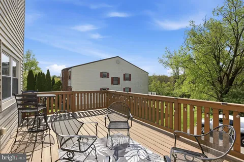 a view of a roof deck with wooden floor and fence