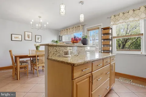 a view of dining table chairs and window