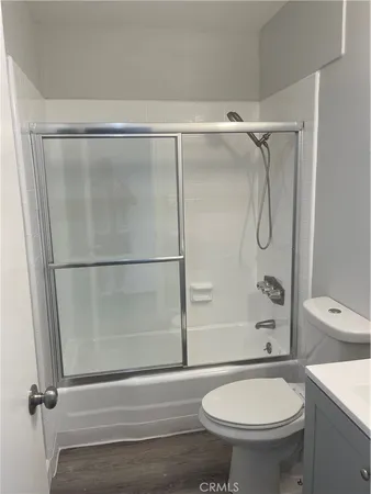a bathroom with a shower a toilet and a shower