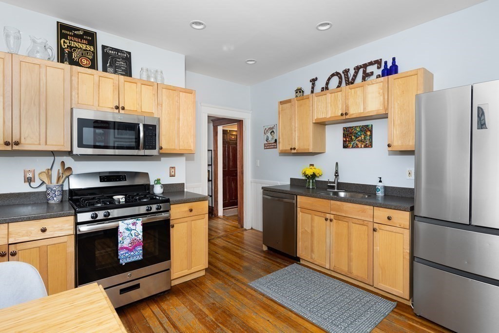 32 Parkton Road, Unit 2 Boston, MA 02130 - Photo 4 of 23 a kitchen with granite countertop a refrigerator stove and microwave