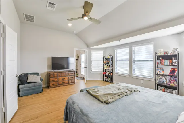 a bedroom with a bed and a flat screen television