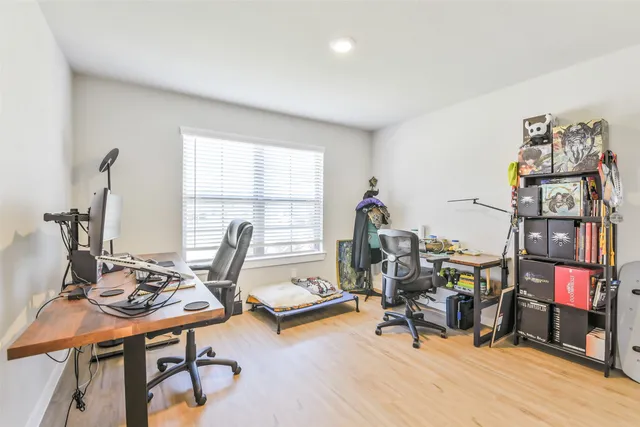 a view of a workspace with furniture and a window