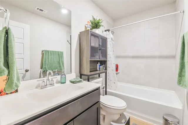 a bathroom with a sink a toilet and a bathtub