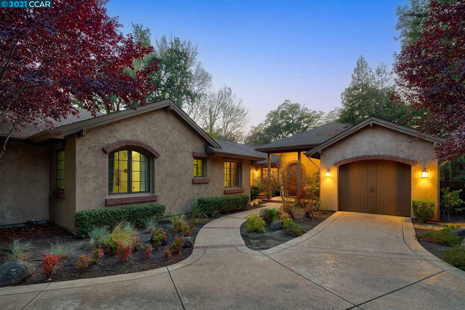a front view of a house with yard and outdoor seating