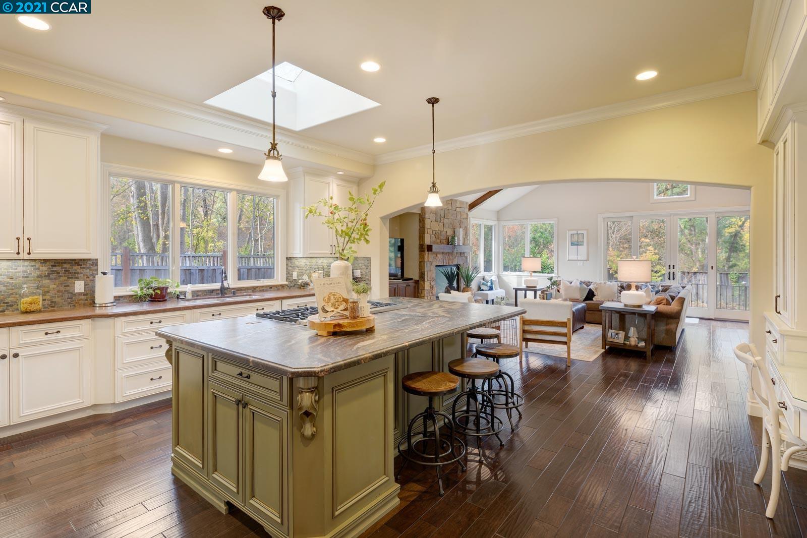 Undisclosed Address Diablo, CA 94526 - Photo 17 of 40 a kitchen with stainless steel appliances granite countertop a stove top oven a dining table and chairs with wooden floor