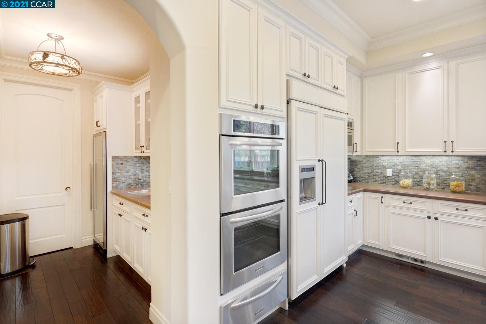Undisclosed Address Diablo, CA 94526 - Photo 18 of 40 a kitchen with granite countertop white cabinets and refrigerator