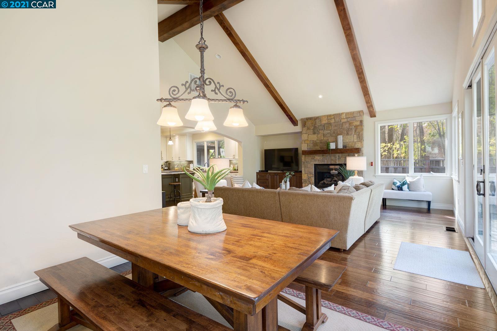 Undisclosed Address Diablo, CA 94526 - Photo 26 of 40 a living room with dining table a table and chairs with wooden floor